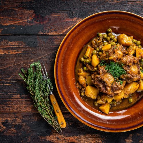 Beef veal oxtails stew with vegetables in a rustic plate.